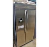 The Samsung RSG257 is a counter-depth refrigerator that has a smooth exterior with concealed door hinges and a concealed grill.