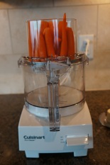 Stacking carrots helps stabilize them for fast, consistent shredding or slicing.