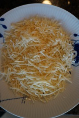 Using the fine side of the shredding disc on parmesan.